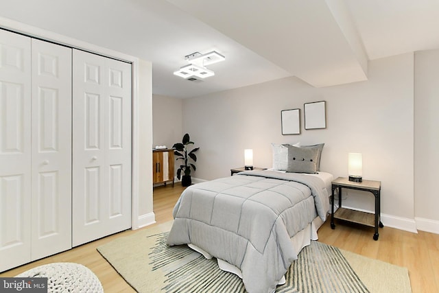 bedroom with a closet and light wood-type flooring