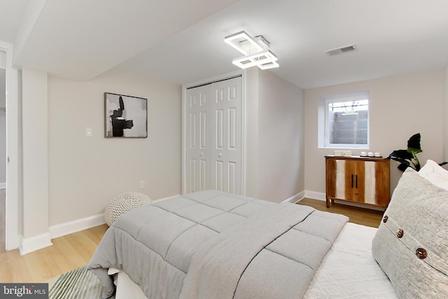 bedroom featuring light wood-type flooring and a closet