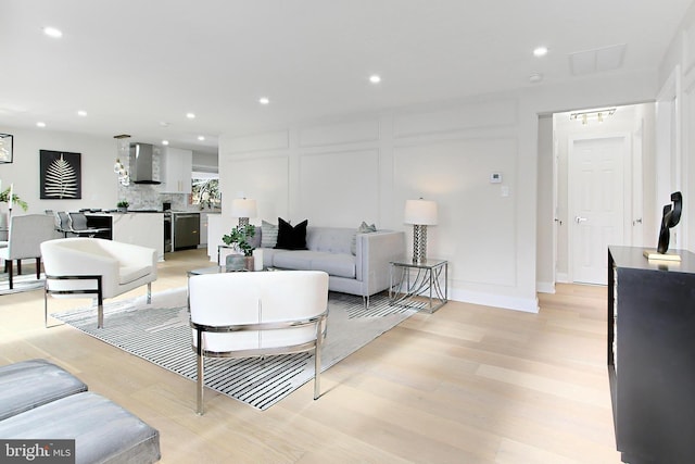 living room featuring light hardwood / wood-style floors and sink