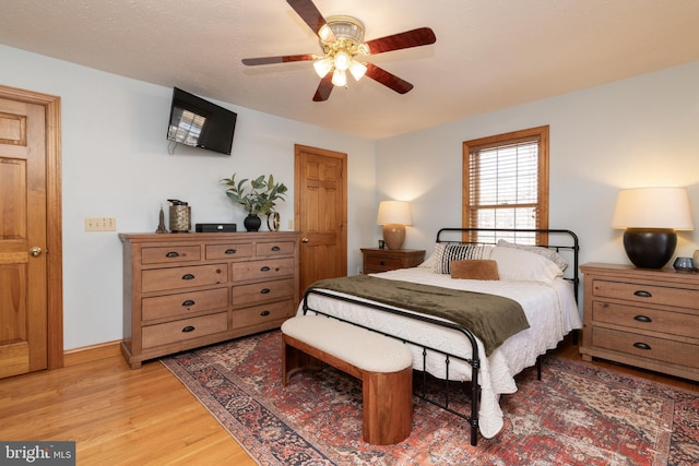 bedroom with light hardwood / wood-style flooring and ceiling fan