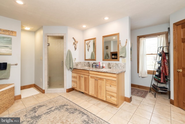 bathroom featuring walk in shower, tile patterned floors, and vanity