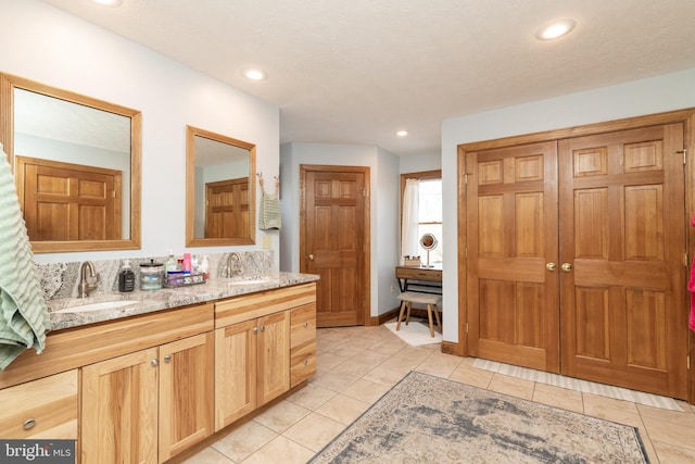 bathroom with tile patterned flooring and vanity