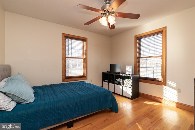 bedroom with ceiling fan and light hardwood / wood-style flooring