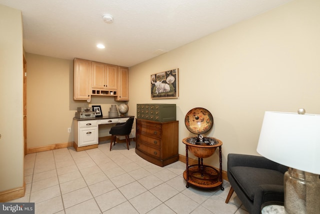 office space featuring built in desk and light tile patterned floors