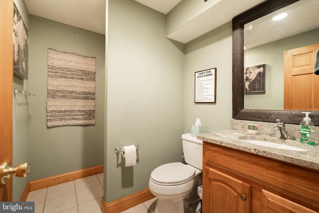 bathroom featuring vanity, tile patterned floors, and toilet