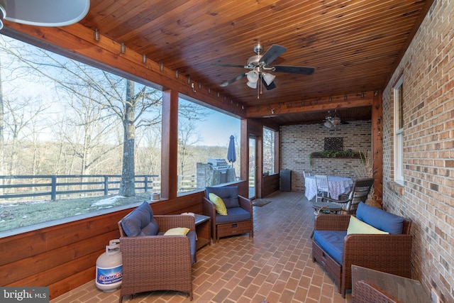 sunroom / solarium with ceiling fan