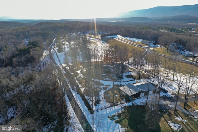 snowy aerial view featuring a mountain view