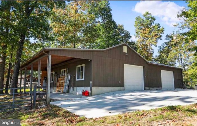 exterior space with a garage and an outbuilding