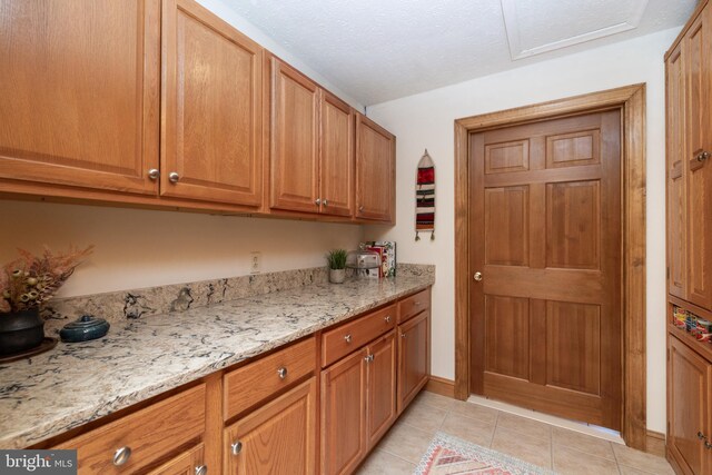 kitchen featuring light stone countertops and light tile patterned floors