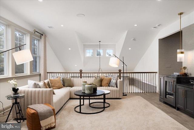 living room featuring vaulted ceiling and light hardwood / wood-style floors