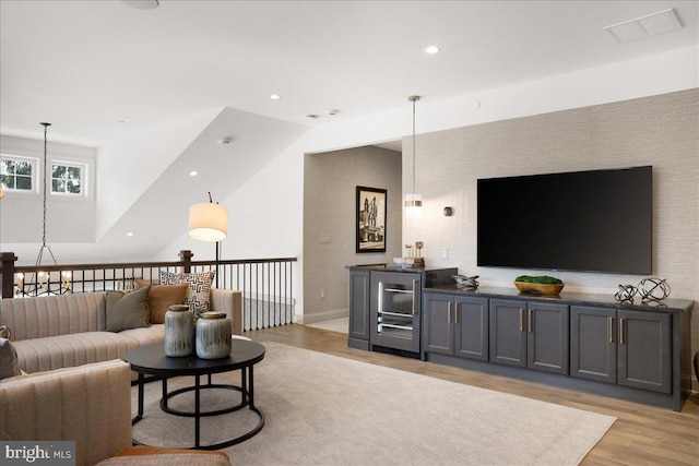 living room featuring light hardwood / wood-style flooring and a chandelier