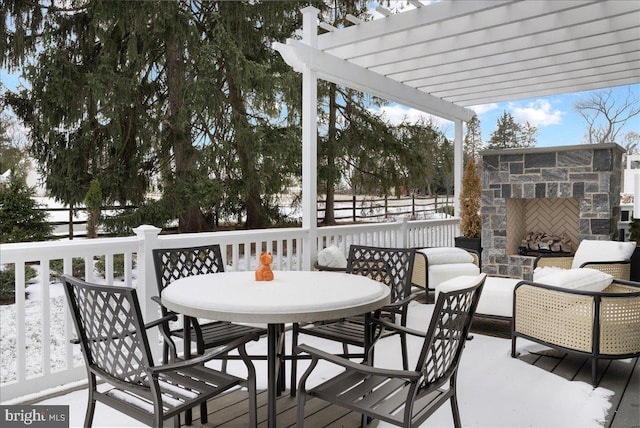 wooden terrace with a pergola and an outdoor stone fireplace