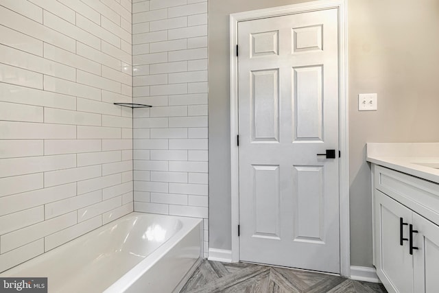 bathroom with vanity, parquet flooring, and shower / washtub combination