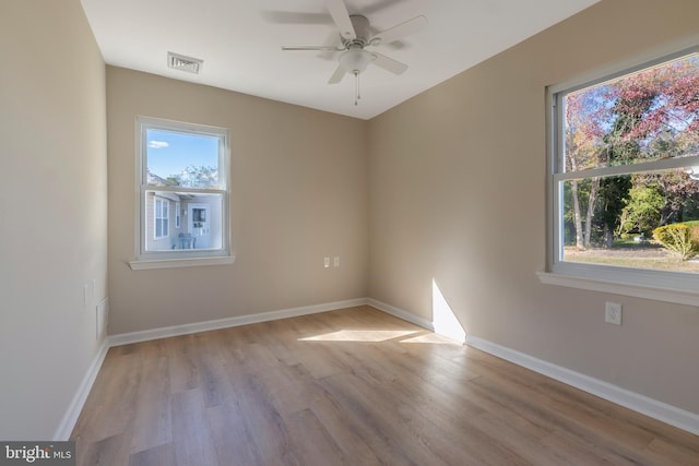 spare room with ceiling fan and light wood-type flooring