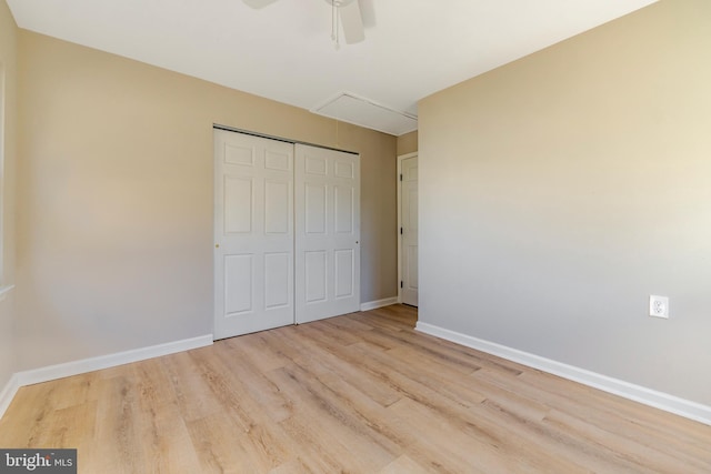 unfurnished bedroom with ceiling fan, a closet, and light hardwood / wood-style floors