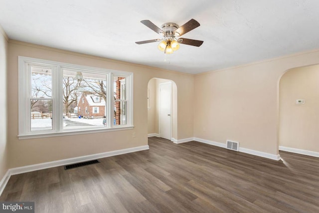 empty room with ceiling fan and dark hardwood / wood-style floors