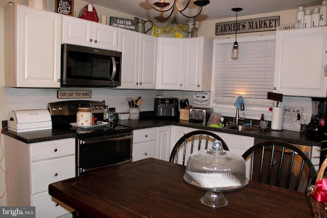 kitchen with white cabinetry, range with electric stovetop, tasteful backsplash, and decorative light fixtures