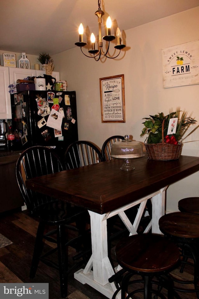 dining room featuring hardwood / wood-style floors and a chandelier