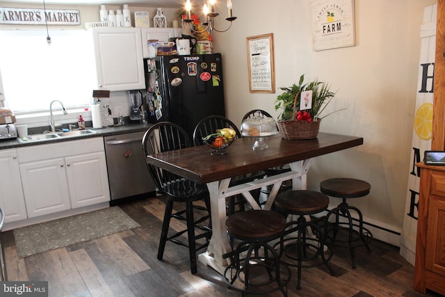 kitchen featuring sink, stainless steel dishwasher, white cabinets, and dark wood-type flooring