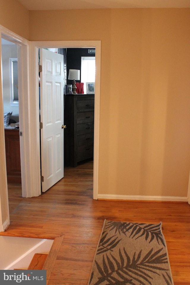 hall with hardwood / wood-style floors