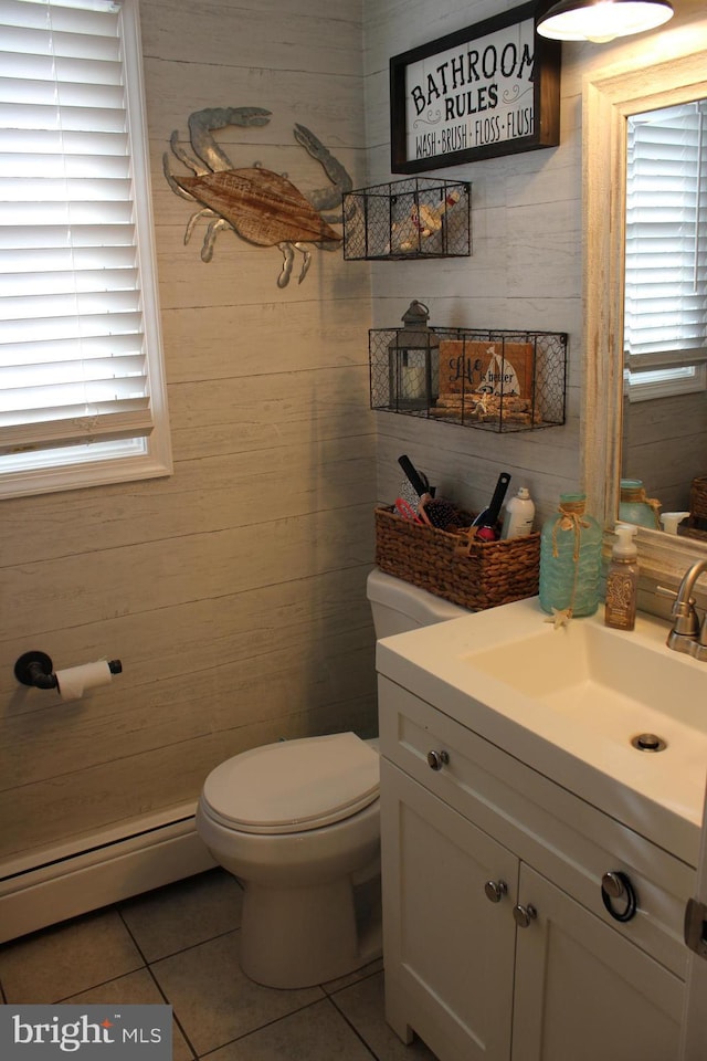 bathroom featuring baseboard heating, tile patterned floors, toilet, and vanity