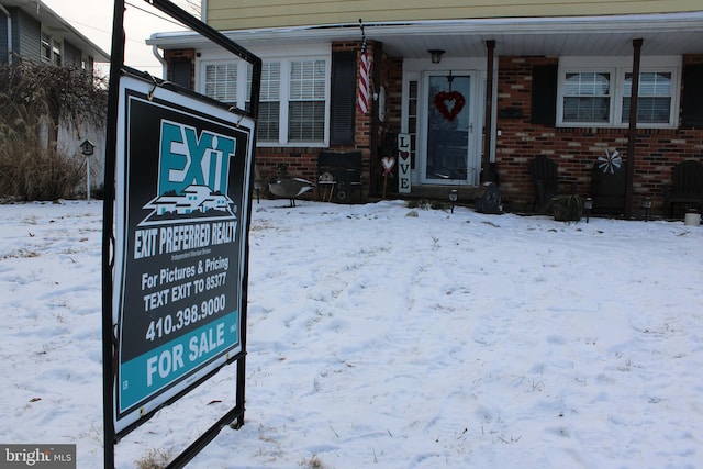 view of snow covered property entrance