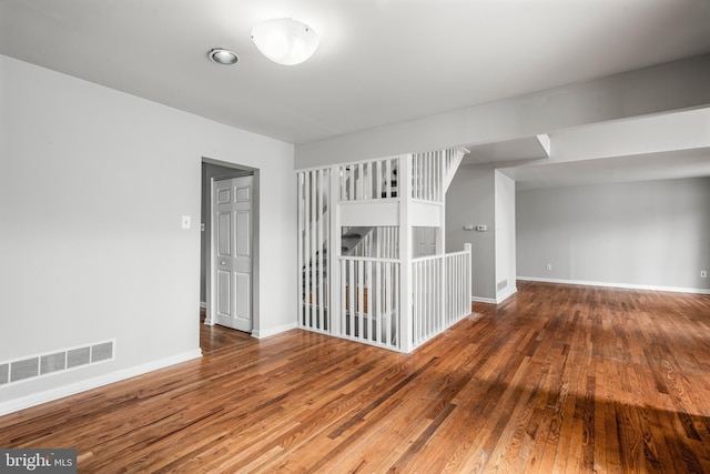 empty room with dark hardwood / wood-style flooring