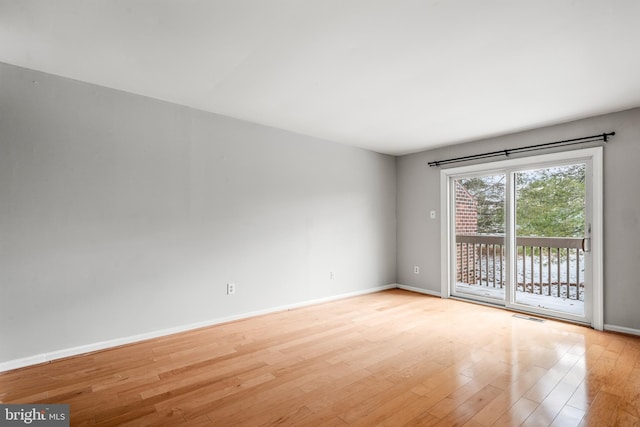 spare room featuring light hardwood / wood-style flooring