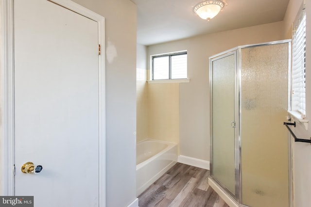 bathroom with plus walk in shower and wood-type flooring