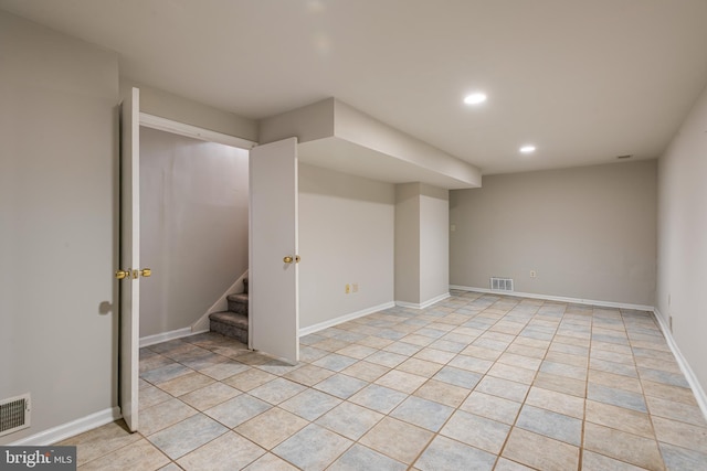 basement featuring light tile patterned floors