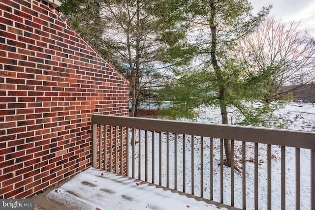 view of snow covered back of property