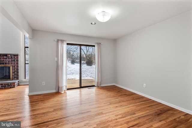 unfurnished living room featuring a fireplace and light wood-type flooring