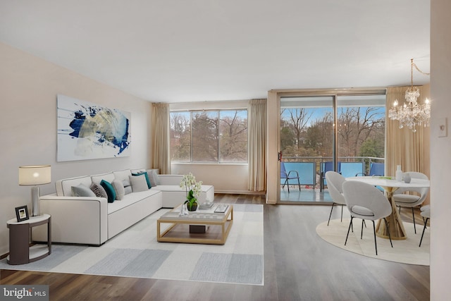 living room with an inviting chandelier and hardwood / wood-style flooring