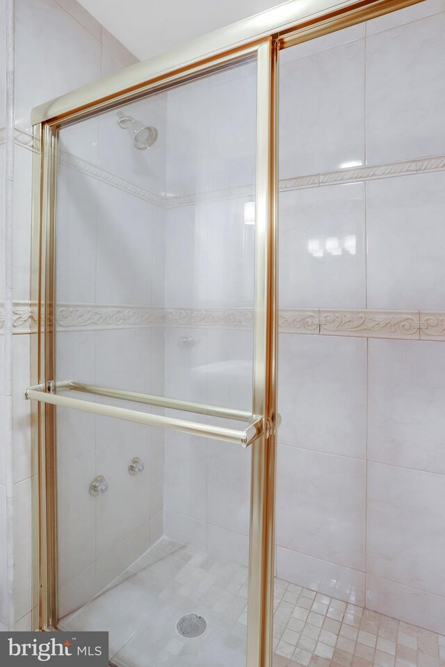 bathroom with a shower with shower door