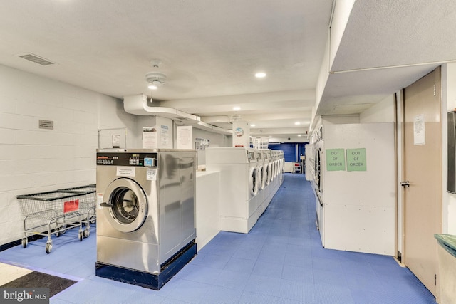 clothes washing area featuring washer and clothes dryer