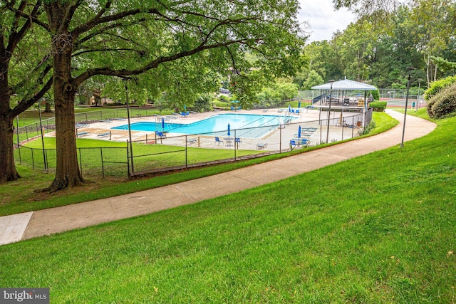 view of swimming pool featuring a gazebo and a yard