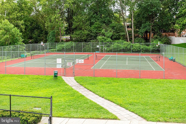 view of sport court with a lawn