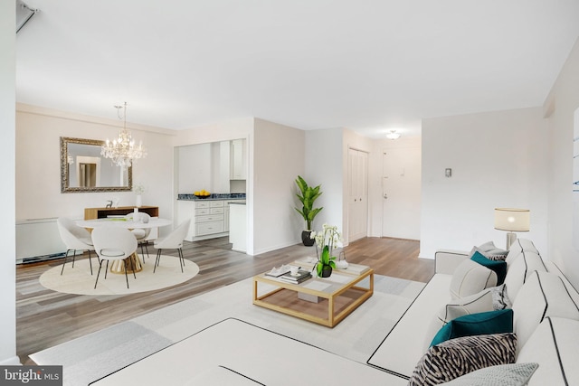 living room with a notable chandelier and hardwood / wood-style floors