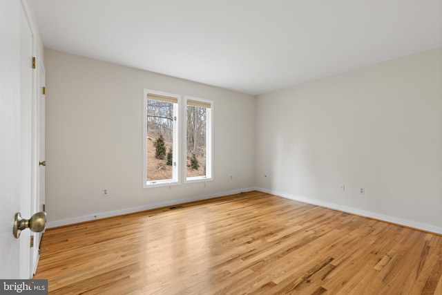 unfurnished room with visible vents, baseboards, and light wood-style floors