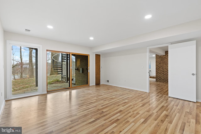 empty room featuring stairway, visible vents, baseboards, recessed lighting, and light wood-style floors