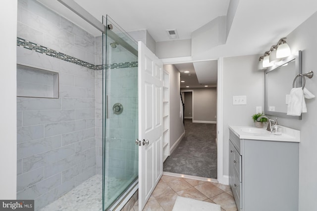 bathroom featuring vanity, tile patterned floors, and a shower with shower door