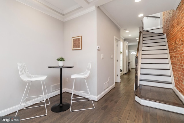 unfurnished dining area with ornamental molding and dark hardwood / wood-style floors