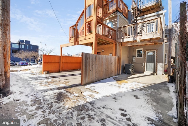 snow covered house with central AC unit