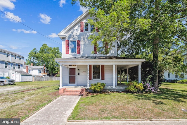 view of front facade with covered porch and a front yard