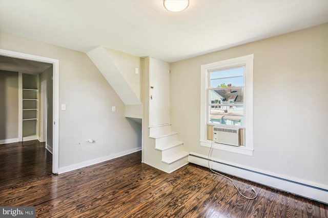 interior space featuring cooling unit, dark hardwood / wood-style floors, and a baseboard heating unit