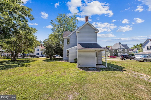 rear view of property featuring a yard