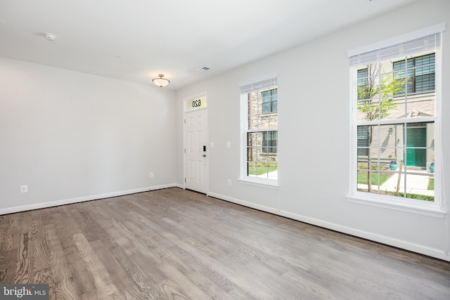 empty room with light hardwood / wood-style floors