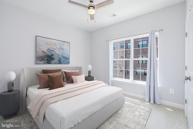 bedroom with ceiling fan and light colored carpet