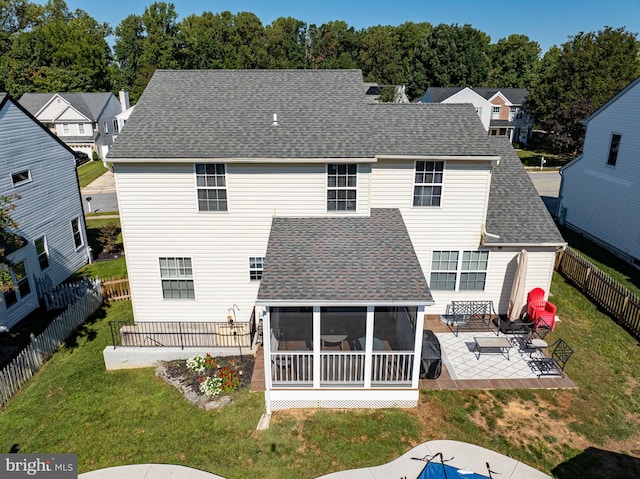 back of house with a patio, a lawn, and a sunroom