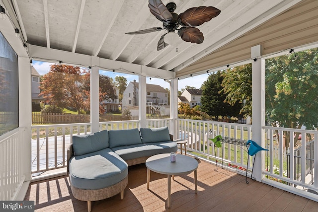 sunroom with lofted ceiling, ceiling fan, and a wealth of natural light